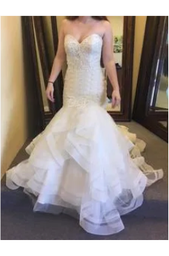 A woman wearing a strapless mermaid-style wedding dress.